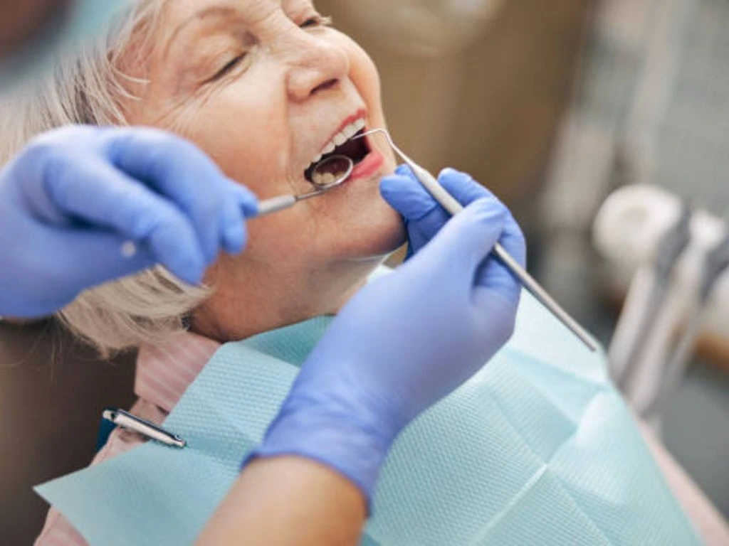 Patient receiving dental implant treatment with a dentist in a modern dental clinic